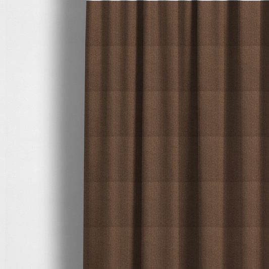 The fabric used to create these made-to-measure curtains is a dark chocolate or mocha brown textile with a tight diagonal twill weave. The fabric is woven with a deep brown base interspersed with fine, lighter threads that create a subtle shimmering or "salt and pepper" effect across the surface.
