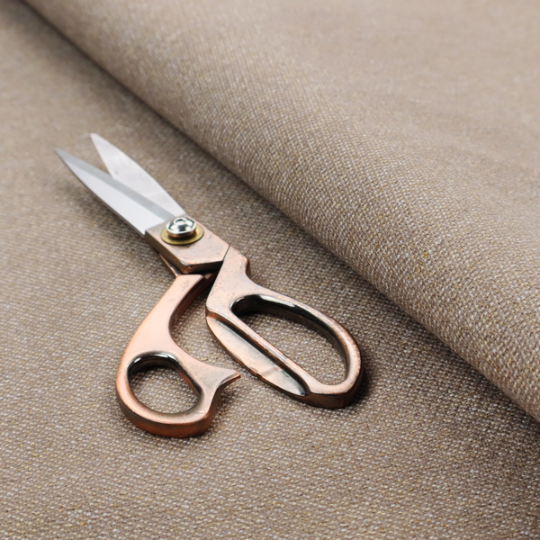 A muted taupe or mushroom-coloured textile with a tight diagonal twill weave. The fabric is a multi-tonal blend, interlacing earthy brown and grey-beige yarns with fine cream and gold flecks, creating a sophisticated heathered effect.