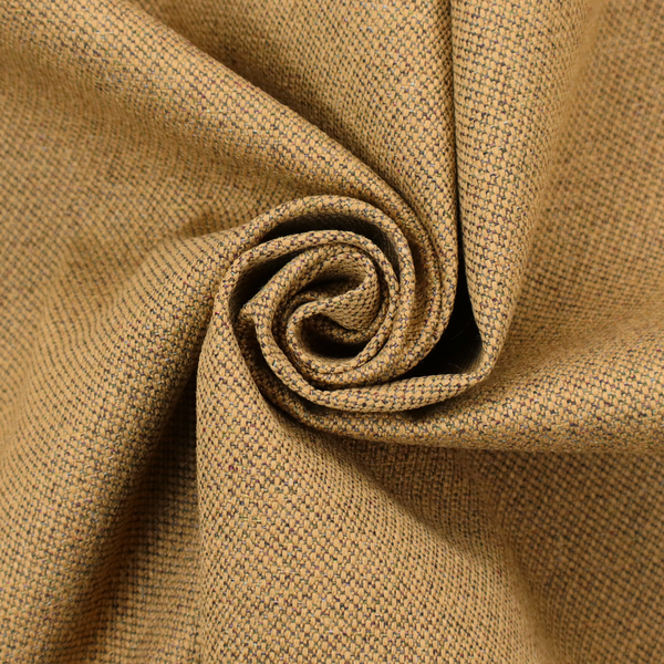 A golden mustard or ochre textile featuring a dense diagonal twill weave. The fabric is a multi-tonal blend, interlacing warm yellow-gold yarns with subtle flecks of darker brown and charcoal, creating a rich, heathered depth.