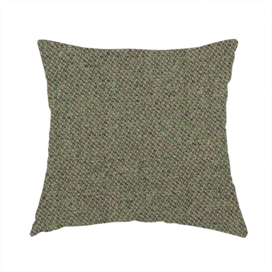 The fabric used to create this handmade cushion is a olive or moss green textile featuring a dense diagonal twill weave. The fabric is a multi-tonal blend, interlacing earthy brownish-grey yarns with vibrant lime green flecks, creating a textured, heathered appearance.