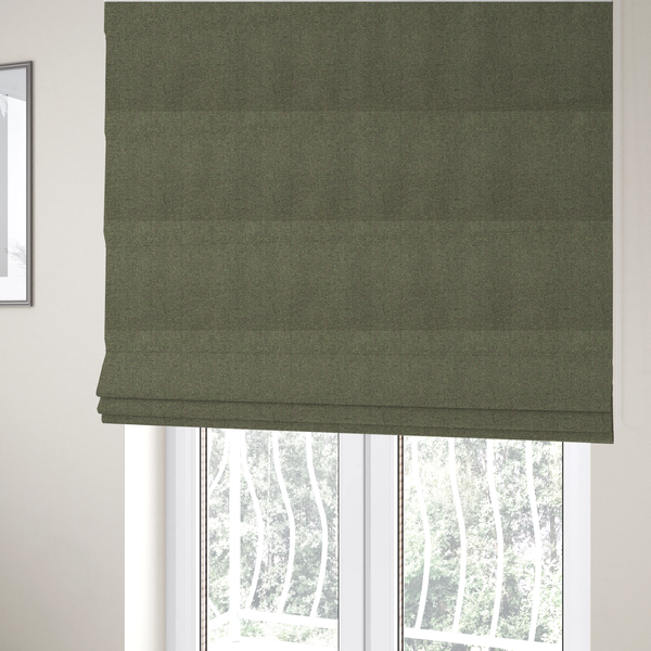 the fabric used to create these Roman blinds is a olive or moss green textile featuring a dense diagonal twill weave. The fabric is a multi-tonal blend, interlacing earthy brownish-grey yarns with vibrant lime green flecks, creating a textured, heathered appearance