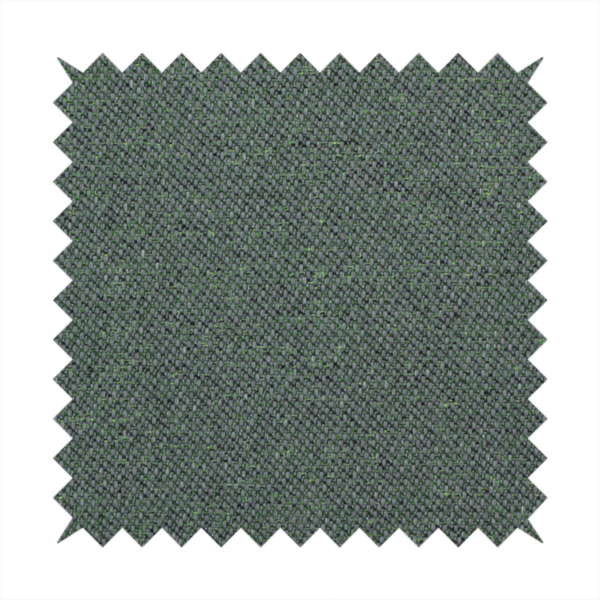 A charcoal or slate grey textile with a tight diagonal twill weave. The fabric is a multi-tonal blend, interlacing dark grey yarns with subtle, bright lime green flecks that provide a modern, heathered dimension.