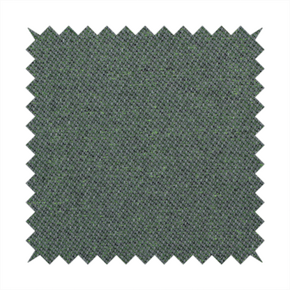 A charcoal or slate grey textile with a tight diagonal twill weave. The fabric is a multi-tonal blend, interlacing dark grey yarns with subtle, bright lime green flecks that provide a modern, heathered dimension.