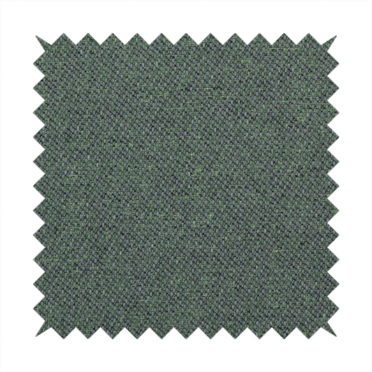 A charcoal or slate grey textile with a tight diagonal twill weave. The fabric is a multi-tonal blend, interlacing dark grey yarns with subtle, bright lime green flecks that provide a modern, heathered dimension.