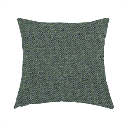 The fabric used to create this handmade cushion is a charcoal or slate grey textile with a tight diagonal twill weave. The fabric is a multi-tonal blend, interlacing dark grey yarns with subtle, bright lime green flecks that provide a modern, heathered dimension.