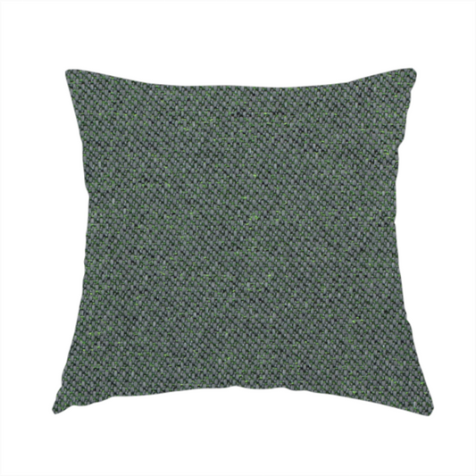 The fabric used to create this handmade cushion is a charcoal or slate grey textile with a tight diagonal twill weave. The fabric is a multi-tonal blend, interlacing dark grey yarns with subtle, bright lime green flecks that provide a modern, heathered dimension.