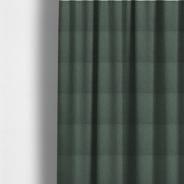 The fabric used to create these made-to-measure curtains is a charcoal or slate grey textile with a tight diagonal twill weave. The fabric is a multi-tonal blend, interlacing dark grey yarns with subtle, bright lime green flecks that provide a modern, heathered dimension.