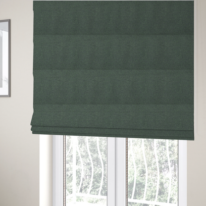 The fabric used to create these Roman blinds is a charcoal or slate grey textile with a tight diagonal twill weave. The fabric is a multi-tonal blend, interlacing dark grey yarns with subtle, bright lime green flecks that provide a modern, heathered dimension.