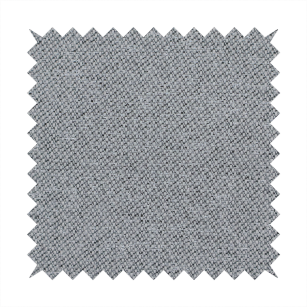 A cool steel or light blue-grey textile featuring a tight diagonal twill weave. The fabric is a multi-tonal blend, interlacing medium grey yarns with pale blue and crisp white threads, creating a clean, heathered appearance.