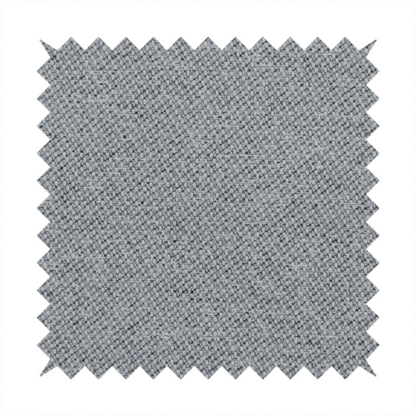 A cool steel or light blue-grey textile featuring a tight diagonal twill weave. The fabric is a multi-tonal blend, interlacing medium grey yarns with pale blue and crisp white threads, creating a clean, heathered appearance.