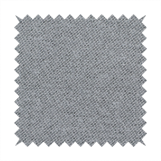 A cool steel or light blue-grey textile featuring a tight diagonal twill weave. The fabric is a multi-tonal blend, interlacing medium grey yarns with pale blue and crisp white threads, creating a clean, heathered appearance.
