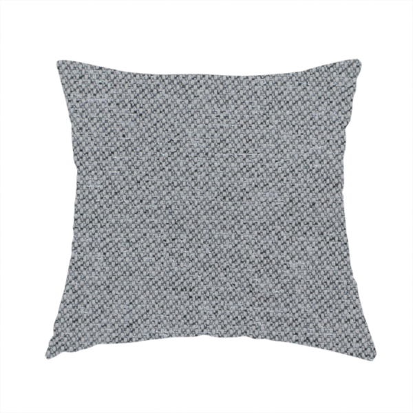 The fabric used to create this handmade cushion is a cool steel or light blue-grey textile featuring a tight diagonal twill weave. The fabric is a multi-tonal blend, interlacing medium grey yarns with pale blue and crisp white threads, creating a clean, heathered appearance.