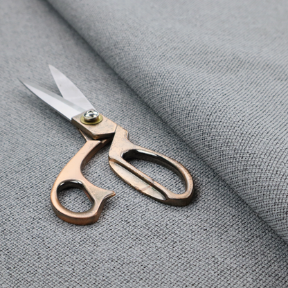 A cool steel or light blue-grey textile featuring a tight diagonal twill weave. The fabric is a multi-tonal blend, interlacing medium grey yarns with pale blue and crisp white threads, creating a clean, heathered appearance.