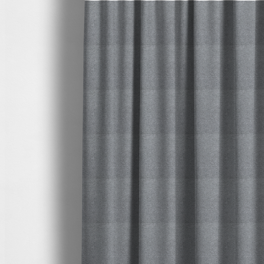 The fabric used to create these made-to-measure curtains is a cool steel or light blue-grey textile featuring a tight diagonal twill weave. The fabric is a multi-tonal blend, interlacing medium grey yarns with pale blue and crisp white threads, creating a clean, heathered appearance.