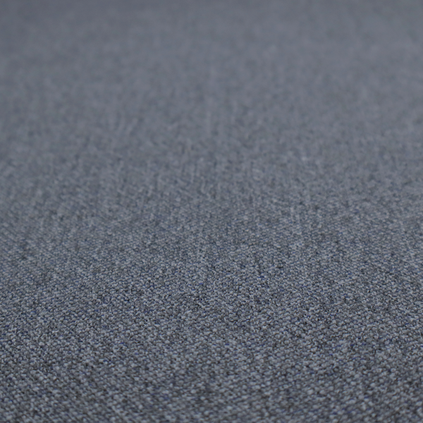 A seal grey textile featuring a tight diagonal twill weave. The fabric is a multi-tonal blend, interlacing deep charcoal and slate yarns with subtle flecks of lighter grey and muted blue, creating a sophisticated, heathered depth.