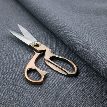 A seal grey textile featuring a tight diagonal twill weave. The fabric is a multi-tonal blend, interlacing deep charcoal and slate yarns with subtle flecks of lighter grey and muted blue, creating a sophisticated, heathered depth.