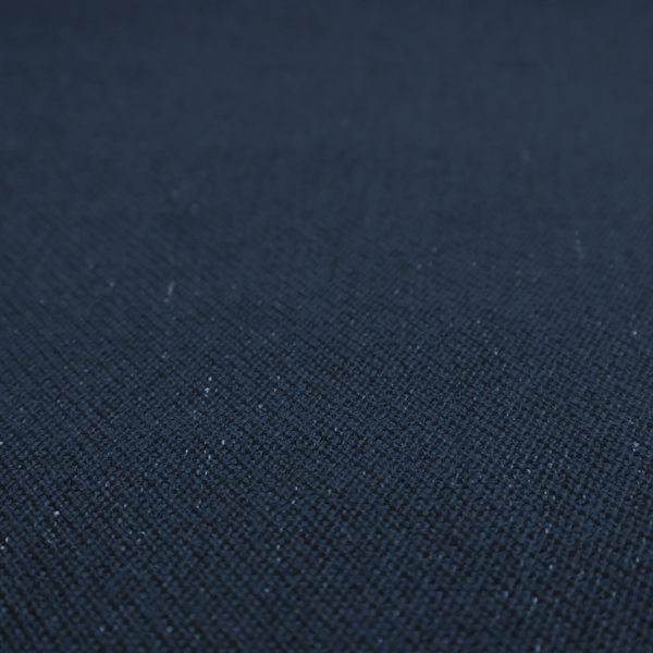 A deep navy or midnight blue textile featuring a tight diagonal twill weave. The fabric is woven primarily with saturated dark blue yarns, interspersed with very fine, sparse white or light grey flecks that create a subtle starlight effect.