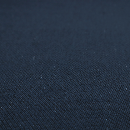 A deep navy or midnight blue textile featuring a tight diagonal twill weave. The fabric is woven primarily with saturated dark blue yarns, interspersed with very fine, sparse white or light grey flecks that create a subtle starlight effect.