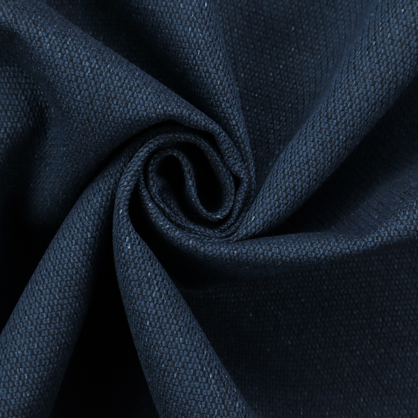 A deep navy or midnight blue textile featuring a tight diagonal twill weave. The fabric is woven primarily with saturated dark blue yarns, interspersed with very fine, sparse white or light grey flecks that create a subtle starlight effect.