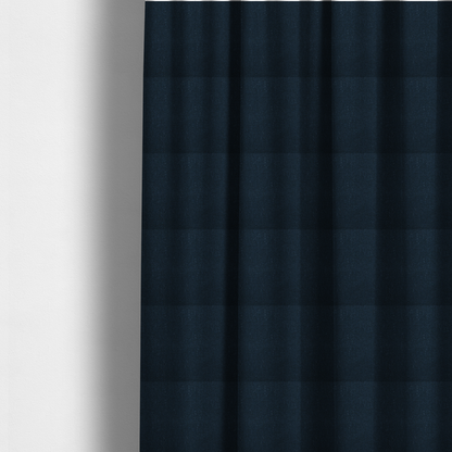The fabric used to create these made-to-measure curtains is a deep navy or midnight blue textile featuring a tight diagonal twill weave. The fabric is woven primarily with saturated dark blue yarns, interspersed with very fine, sparse white or light grey flecks that create a subtle starlight effect.