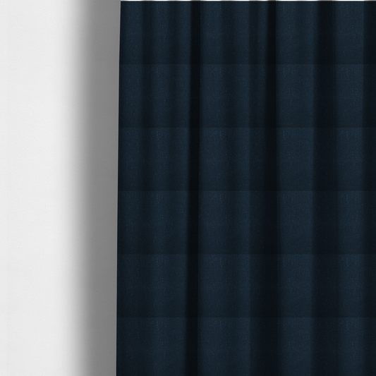 The fabric used to create these made-to-measure curtains is a deep navy or midnight blue textile featuring a tight diagonal twill weave. The fabric is woven primarily with saturated dark blue yarns, interspersed with very fine, sparse white or light grey flecks that create a subtle starlight effect.