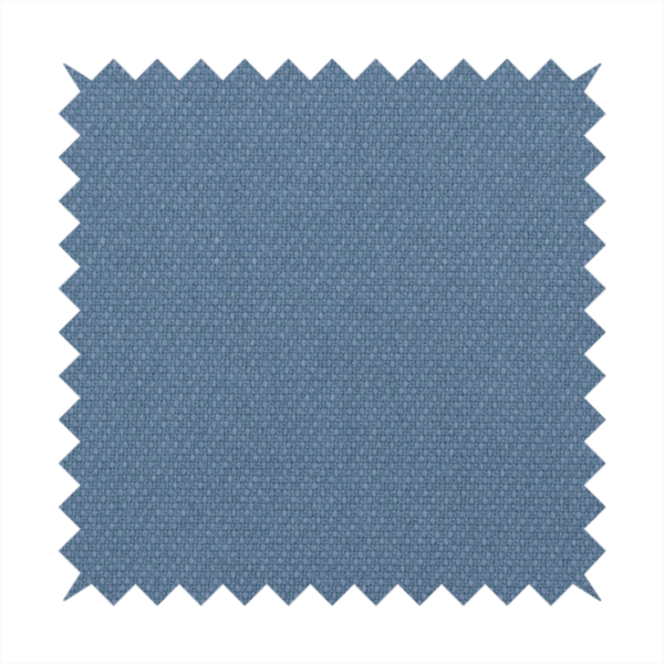 A medium denim or cornflower blue textile featuring a tight diagonal twill weave. The fabric is woven with a blend of soft blue and muted grey-blue yarns, creating a calm, uniform colour profile with subtle tonal depth.