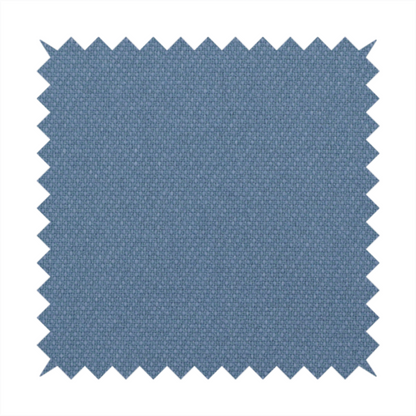 A medium denim or cornflower blue textile featuring a tight diagonal twill weave. The fabric is woven with a blend of soft blue and muted grey-blue yarns, creating a calm, uniform colour profile with subtle tonal depth.