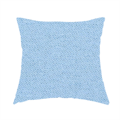 The fabric used to create this handmade cushion is a sky blue or powder blue textile featuring a tight diagonal twill weave. The fabric is woven with bright, airy blue yarns interlaced with crisp white threads, creating a fresh, luminous, and slightly heathered appearance.