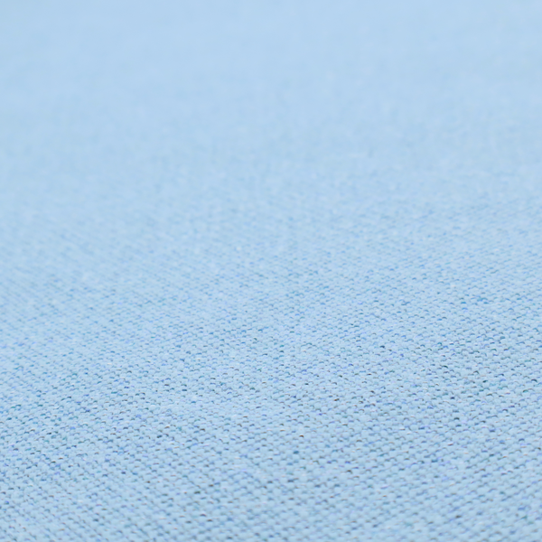 A sky blue or powder blue textile featuring a tight diagonal twill weave. The fabric is woven with bright, airy blue yarns interlaced with crisp white threads, creating a fresh, luminous, and slightly heathered appearance.