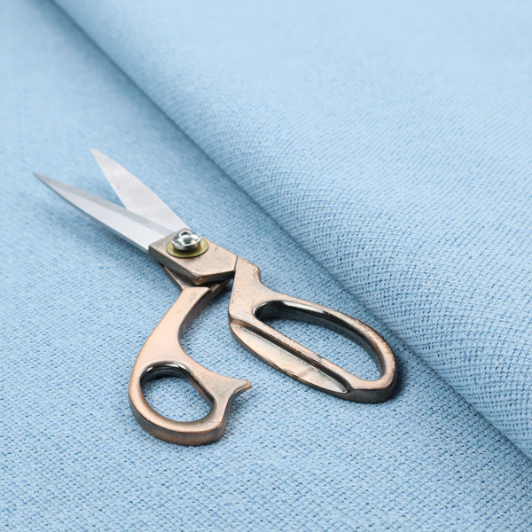 A sky blue or powder blue textile featuring a tight diagonal twill weave. The fabric is woven with bright, airy blue yarns interlaced with crisp white threads, creating a fresh, luminous, and slightly heathered appearance.