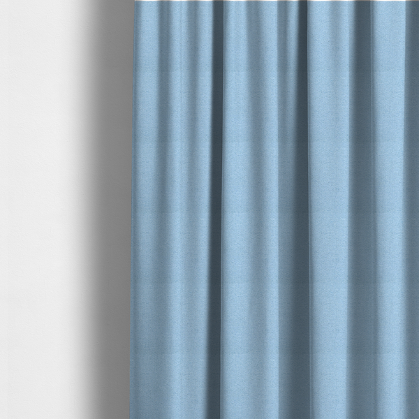 The fabric used to create these made-to-measure curtains is a sky blue or powder blue textile featuring a tight diagonal twill weave. The fabric is woven with bright, airy blue yarns interlaced with crisp white threads, creating a fresh, luminous, and slightly heathered appearance.