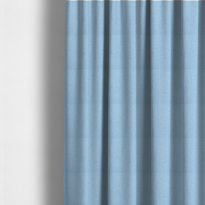 The fabric used to create these made-to-measure curtains is a sky blue or powder blue textile featuring a tight diagonal twill weave. The fabric is woven with bright, airy blue yarns interlaced with crisp white threads, creating a fresh, luminous, and slightly heathered appearance.