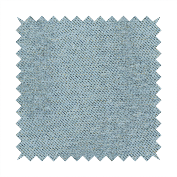 A dusty aqua or pale teal textile featuring a tight diagonal twill weave. The fabric is a multi-tonal blend, interlacing soft blue-green yarns with subtle flecks of grey and pale gold, creating a sophisticated, heathered depth.