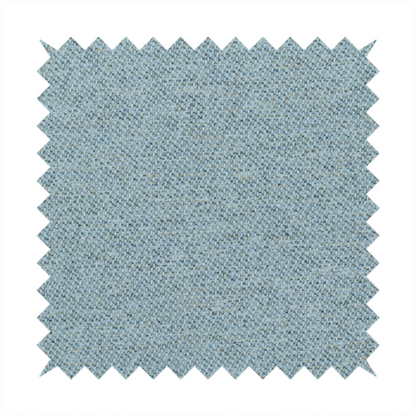 A dusty aqua or pale teal textile featuring a tight diagonal twill weave. The fabric is a multi-tonal blend, interlacing soft blue-green yarns with subtle flecks of grey and pale gold, creating a sophisticated, heathered depth.