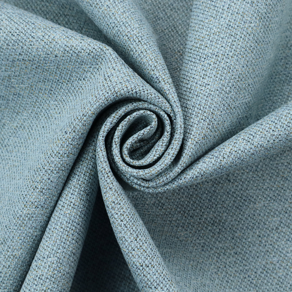 A dusty aqua or pale teal textile featuring a tight diagonal twill weave. The fabric is a multi-tonal blend, interlacing soft blue-green yarns with subtle flecks of grey and pale gold, creating a sophisticated, heathered depth.