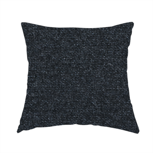 The fabric used to create this handmade cushion is a near-black charcoal base with dense, icy blue and silver flecks.