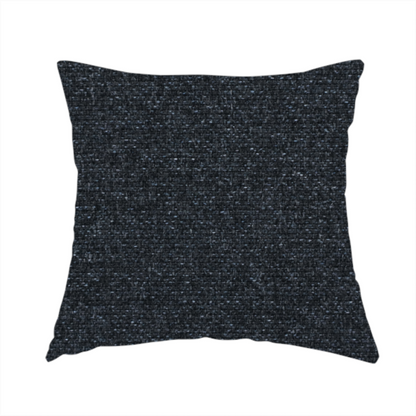 The fabric used to create this handmade cushion is a near-black charcoal base with dense, icy blue and silver flecks.