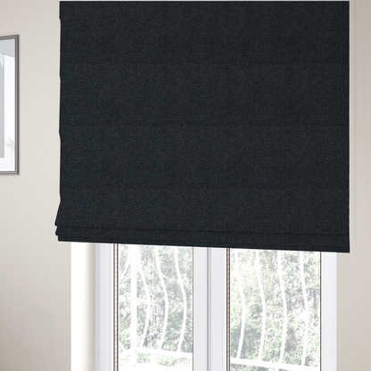 The fabric used to create these Roman blinds is a near-black charcoal base with dense, icy blue and silver flecks.