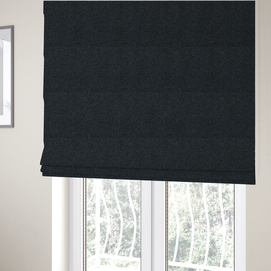 The fabric used to create these Roman blinds is a near-black charcoal base with dense, icy blue and silver flecks.
