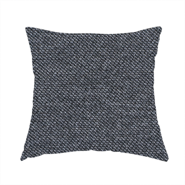 The fabric used to create this handmade cushion is a dark, smoky grey with heavy white flecking; high-contrast heather.