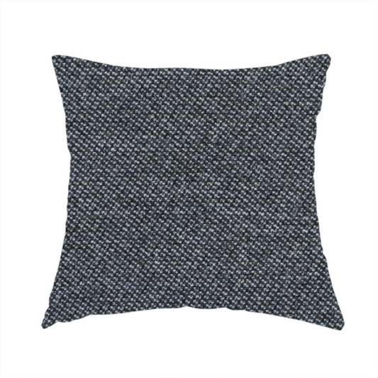 The fabric used to create this handmade cushion is a dark, smoky grey with heavy white flecking; high-contrast heather.