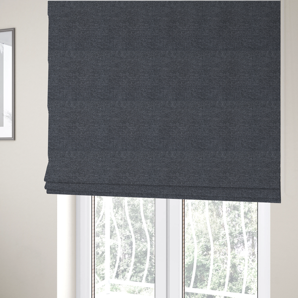 The fabric used to create these Roman blinds is a dark, smoky grey with heavy white flecking; high-contrast heather.