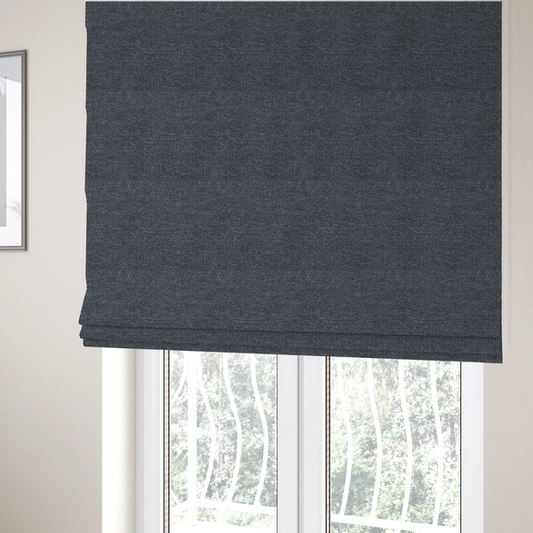 The fabric used to create these Roman blinds is a dark, smoky grey with heavy white flecking; high-contrast heather.