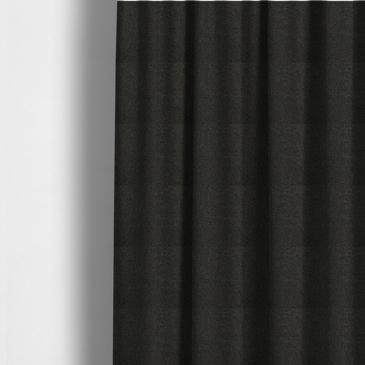 the fabric used to create these made-to-measure curtains is a near-black charcoal base heavily flecked with multi-coloured yarns in gold, rust, and grey.