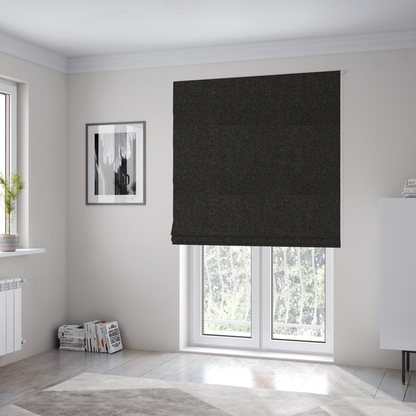 The fabric used to create these Roman blinds is a near-black charcoal base heavily flecked with multi-coloured yarns in gold, rust, and grey.