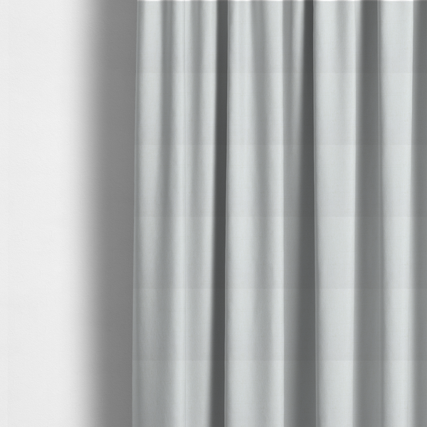 The fabric used to create these made-to-measure curtains is a light-coloured, off-white fabric with a fine, textured weave.