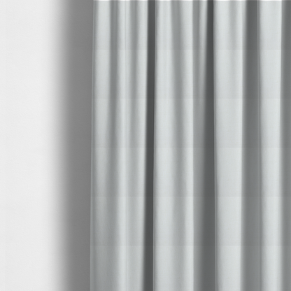 The fabric used to create these made-to-measure curtains is a light-coloured, off-white fabric with a fine, textured weave.