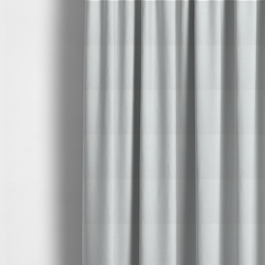 The fabric used to create these made-to-measure curtains is a light-coloured, off-white fabric with a fine, textured weave.