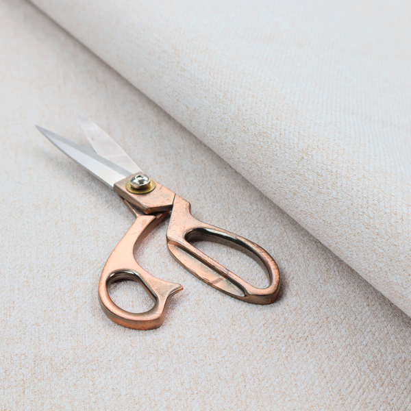 A light beige upholstery fabric with a fine, textured weave.