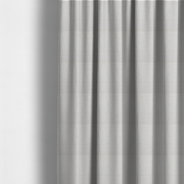 The fabric used to create these made-to-measure curtains is a light beige upholstery fabric with a fine, textured weave.